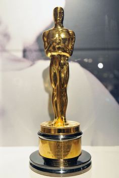 an oscar statue sitting on top of a table