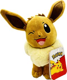 a stuffed animal with a pokemon book in it's lap and an image of pikachu on the back