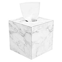 a tissue dispenser sitting on top of a white box