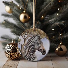 a ceramic ornament with a zebra on it next to a christmas tree and ornaments