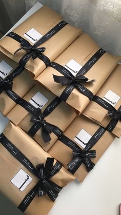 many wrapped packages with black ribbon tied around them