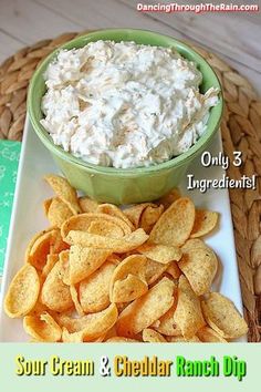 a bowl of cream cheese and chips on a plate with the words sour cream and cheddar ranch dip