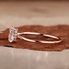 a close up view of an engagement ring on a leaf