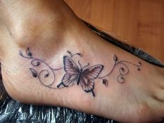 a foot with a butterfly tattoo on it