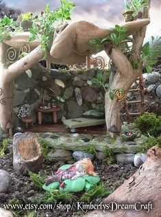 a fairy garden with lots of rocks and plants