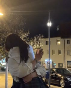 a woman is hugging her friend on the street