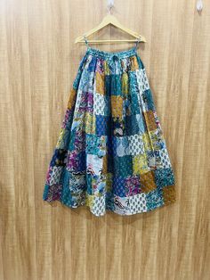 a colorful skirt hanging on a wooden wall