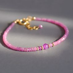 Dainty beaded bracelet with a row of exquisite, candy pink sapphire roundels. In the midst of these beautiful faceted gems, set apart by couple of gold filled roundels sits a a small nugget of star cut, silver sheen, pink sapphire nugget. Made adjustable from 7.25 to 8.5 inches. Sweet on its own, perfect for layering, amazing gift for someone special. Thank you for looking! Please contact me if you have any questions or requests. Free domestic First Class shipping. Gift wrap included and always Dainty Pink Bracelets With Gemstone Beads, Dainty Pink Gemstone Bead Bracelets, Dainty Pink Gemstone Beads Bracelet, Faceted Rondelle Beaded Bracelets, Elegant Faceted Beaded Bracelets With Round Beads, Pink Rondelle Beaded Bracelets, Hand-strung, Pink Rondelle Beaded Bracelets, Pink Rondelle Elegant Jewelry, Pink Gemstone Bracelets For Jewelry Making