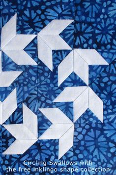 three white arrows are shown in the middle of a blue and white quilting pattern