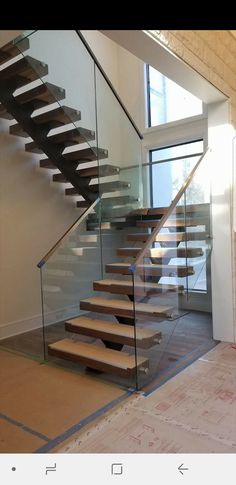 the stairs are made of glass and wood