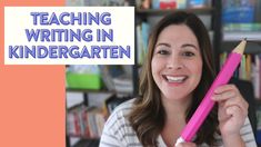 a woman holding a pink pencil in front of a bookcase with the words teaching writing in