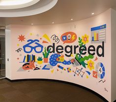 a curved wall painted with the word'tagged'in black and white, surrounded by colorful graphics