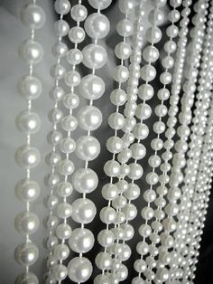 white beads hanging from the ceiling in a room