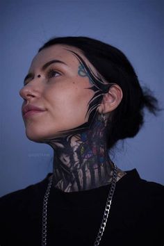 a woman with tattoos on her face and neck