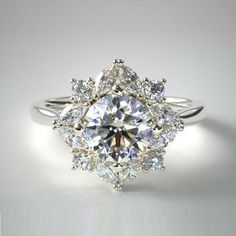 a diamond ring is shown on a white surface, with the center stone surrounded by smaller diamonds