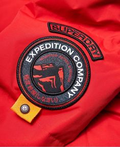 the expedition company logo is on an orange jacket