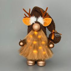 a brown and white stuffed animal with lights on it's head, standing upright