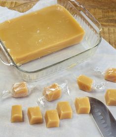 some butter cubes are sitting next to a knife