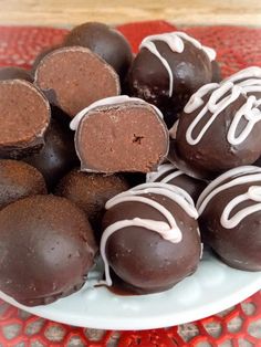 chocolates are arranged on a plate with white icing