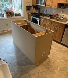 the kitchen is being remodeled with new cabinets and flooring in place for the appliances to be installed