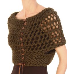 a woman is wearing a brown knitted top