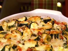 a casserole dish is shown with cheese and zucchini toppings on it