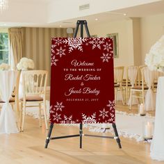 a red and white wedding sign with snowflakes on it in the middle of a room