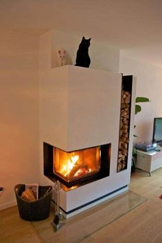 a cat sitting on top of a fireplace in a living room