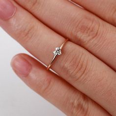 a woman's hand with a diamond ring on it