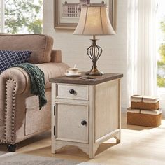 a living room scene with focus on the end table and chair, which has a lamp on it