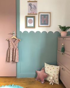 a baby's room with pink and blue walls