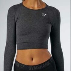 Never Worn. Perfect Condition Except For Interior Tag That Got Caught On Something While Storing (See Picture). Can Not Be Seen When Wearing. Dark Grey. Gymshark Long Sleeve, Black Long Sleeve Crop Top, Gymshark Women, Workout Attire, Training Tops, Gym Tops, Cropped Tops, Athletic Outfits, Long Sleeve Crop