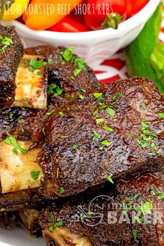 the ribs are cooked and ready to be eaten with fresh vegetables in the bowl behind them