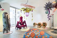 a room filled with lots of colorful sculptures