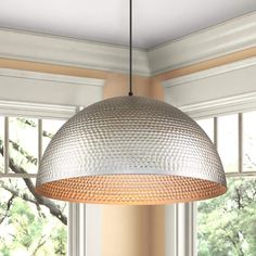 a light fixture hanging over a dining room table