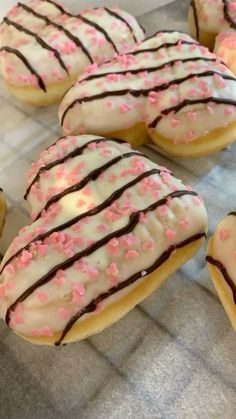 there are many donuts with pink sprinkles on them