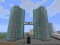 two tall buildings are in the middle of a minecraft video game, one is green and the other is blue