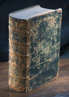 an old book sitting on top of a wooden table