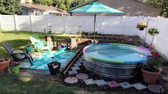 an inflatable pool surrounded by potted plants and patio furniture with umbrella over it