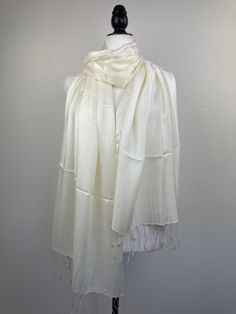 "This is an all season shawl. This versatile shawl can be used to dress up an outfit for a special evening, a wedding or as a neck scarf in the winter. Easy to carry anywhere, perfect for when you need it at a restaurant or at the office  in air conditioning or a cool summer evening.  Effortlessly give a dress a new look by simply adding this shawl. A must have when you travel! The color is very close however is not exact. I tried to to capture the color but was not able to get the exact color under any lighting. If you are trying to match something and would like more pictures, I will be happy to send you more pictures. The Ivory shawl has a small pull/hole, and a small stain as pictured, used as a scarf it will not show, used as a shawl as well it is very small defect.  It also makes the Formal Shawl, Shawl Wedding, Bridal Cover Up, Cream Silk, Silk Shawl, Pashmina Scarf, Cool Summer, Neck Scarf, Summer Evening