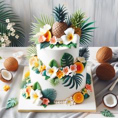 a white cake decorated with tropical flowers and coconuts