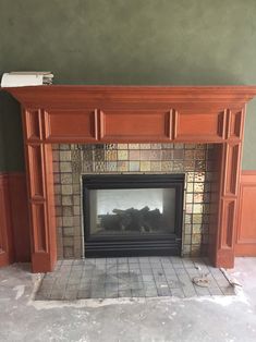 an empty fireplace in the middle of a room