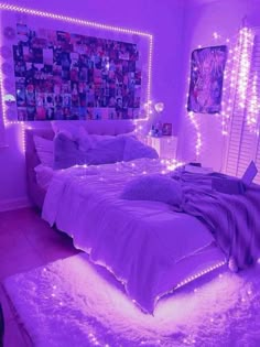 a bedroom with purple lights and pictures on the wall above the bed is lit up