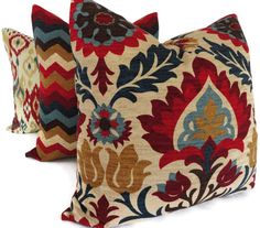 three decorative pillows with different colors and designs on the same pillow cover, one is multicolored