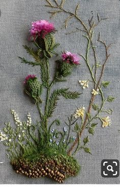 some flowers and plants are sitting on a gray table cloth with the words'69'written below it