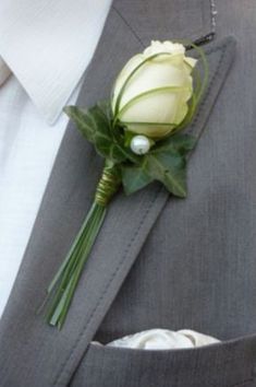 a boutonniere with a white rose on it