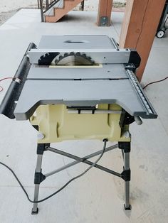 a table saw is sitting on top of a stand