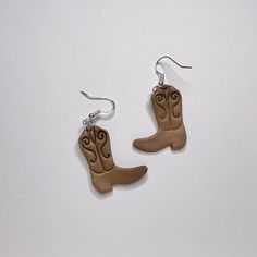 pair of cowboy boots earrings on white background