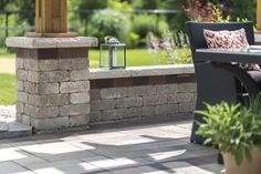 an outdoor patio with chairs, table and fire pit