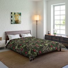 a bedroom with a bed, dresser and lamp in front of a window on the wall